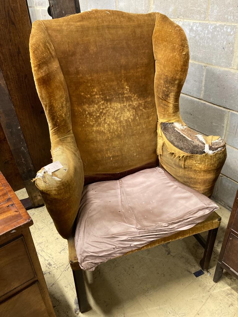 A George III provincial wing armchair, width 83cm, depth 60cm, height 124cm